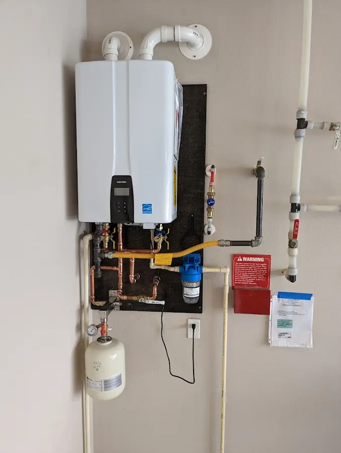 Professional plumber installing copper piping in a Ennis home